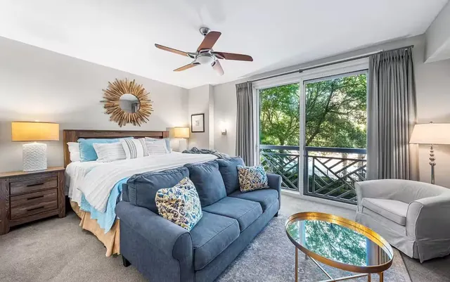 King bedroom and sitting area with balcony view
